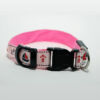 Close up of buckle, adjustment slide, and id tag ring on pink and white nautical themed dog collar