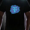 Guy wearing T-Mobile Logo on LED shirt lighting up in dark setting