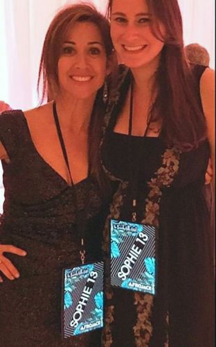 two young women at special event wearing lanyard and hanging light up panel with "Sophie 13" lighting up like a VIP badge