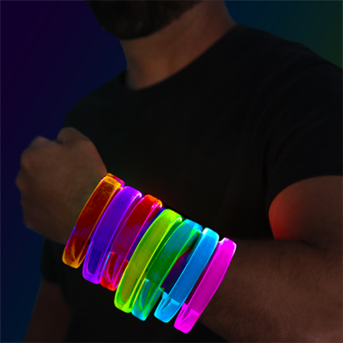 Guy wearing arm full of LED bracelets in rainbow colors