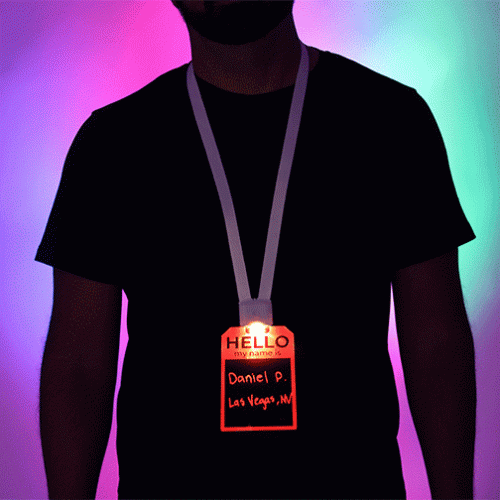 Guy wearing LED name tag badge that is lighting up in different colors