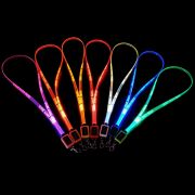 Seven LED lanyards lined up in a dark room glowing pink, orange, yellow, red, white, blue, and green with custom logo laser engraved onto them