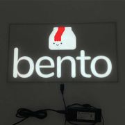 Bento box logo and text glowing brightly for el poster