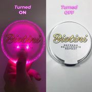 Biotini custom branded LED coaster shown on and off side by side