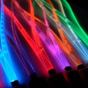 Close up on custom engraved LED lanyards in rainbow colors