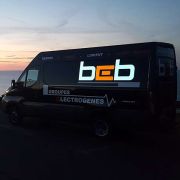 BEB lettering lighting up on side of van