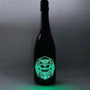 Champagne bottle with EL panel design lighting up the logo bright green in dark room