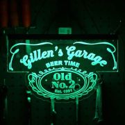 Gillen's Garage custom designed bar neon sign on acrylic glowing green