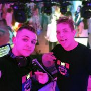 Two DJs at event wearing customized light up t-shirts