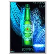 Heineken beer bottle with water and crystal designs behind illuminating brightly on a poster in an aluminum frame