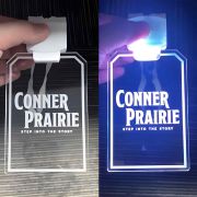 Conner prairie laser engraved logo on acrylic ID badge turned off on left side turned on on right side