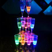 Stacked tower of LED champagne flutes lighting up bright neon colors