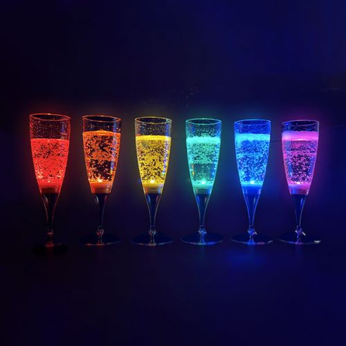 Line of 6 different colored LED champagne flutes lighting up in a rainbow pattern