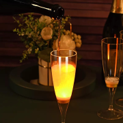 champagne being poured into a drink activated LED champagne flute illuminating bright yellow