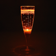 Orange LED champagne flute lighting up bright orange