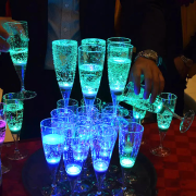 LED champagne glass tower with glasses stacked up glowing bright blue and green