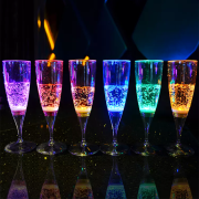 Line of LED champagne glasses on top of bar