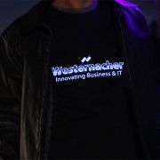 Close up of light up shirt for IT company lighting up like an equalizer under leather jacket