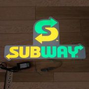 sub way logo lighting up on ground on EL poster