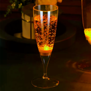 Yellow LED Champagne flute filled with champagne bright yellow