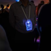 Man wearing a light up name badge with lanyard at an event
