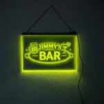 Custom engraved LED hanging sign for Jimmy’s Bar illuminated in yellow-green with beer and cocktail icons