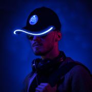 Guy wearing bright light up baseball hat with a blue glowing brim with light up logo