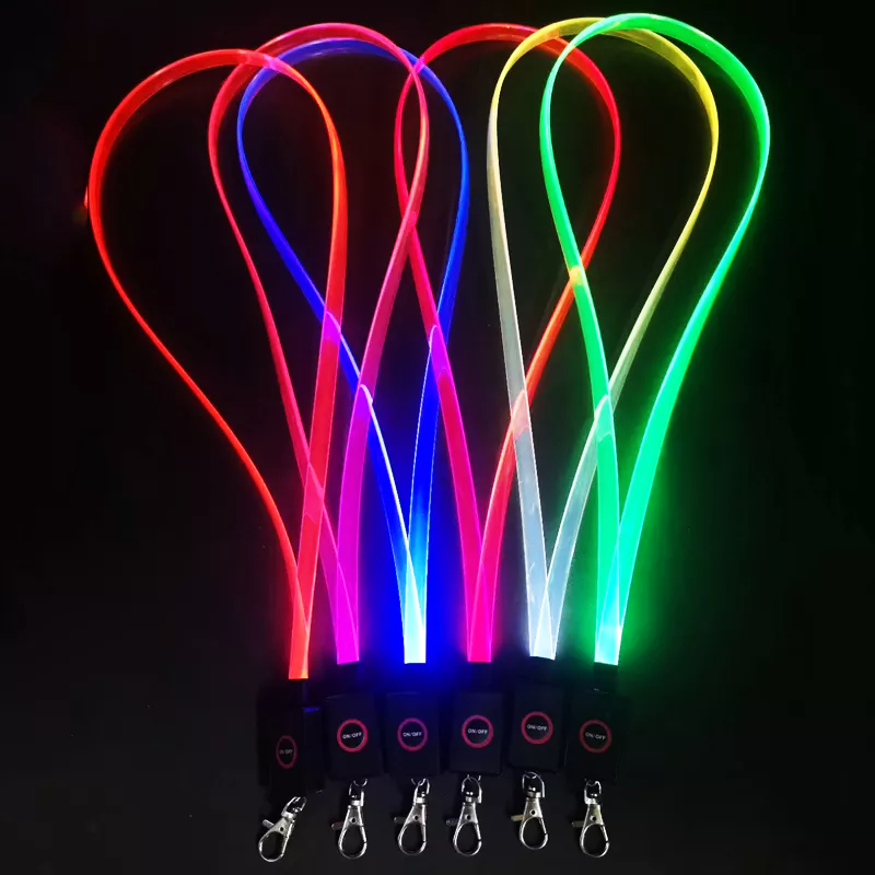 Six LED lanyards lighting up in a row different bright glowing colors orange, pink, blue, red, white, and green