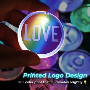 close up of hand holding custom Love Wins political LED pin in front of other LED pin designs in the background