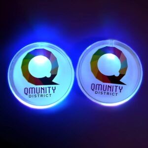 Two branded LED Pins Glowing in the Dark