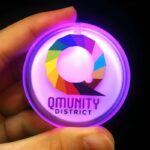 Qmunity District rainbow Q logo printed on pink LED pin