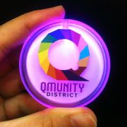 Qmunity District rainbow Q logo printed on pink LED pin