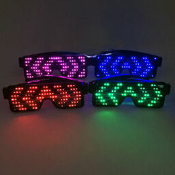 All 4 color LED sunglasses lined up in two rows each lighting up the same animated pattern glowing bright pink, blue, red and green