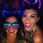Two girls at party wearing LED kitty headbands and LED stunner shades lighting up