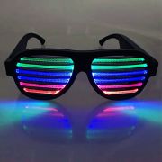 Sound reactive LED shutter shade sunglasses lighting up orange, pink, blue and green in a dark space
