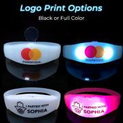 Two silicone remote activated bracelets with printed logo
