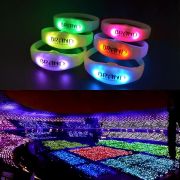 Split image of six stacked silicone LED bracelets each lighting up a different color shown on top of a stadium full of LED bracelets all lighting up a different color depending on the zone