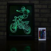Image of dirt biker on framed acrylic laser engraved design on table with remote control to make it change colors