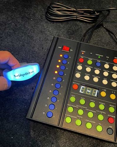 Customized LED bracelet next to 10 zone remote controller
