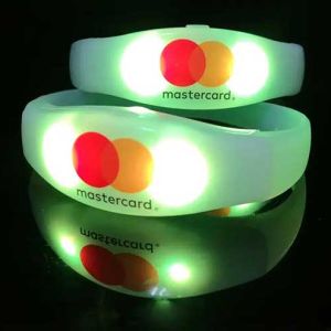 Mastercard logo custom printed onto light up bracelets glowing bright yellow