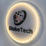 Technology company logo UV printed and lighting up through neon sign