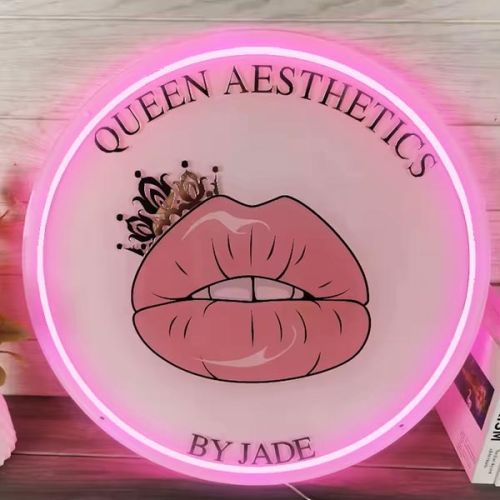 Queen aesthetics small business logo lighting up on hot pink LED neon sign