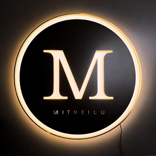 Branded logo neon sign lighting up on black acrylic