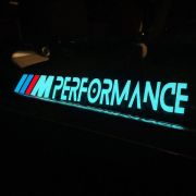glowing el panel with performance logo illuminating on a car in the dark