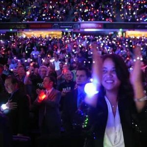 crowd at large stadium all wearing LED bracelets that sync with wireless remote controlled