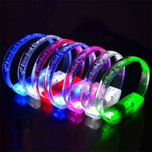 Rocket Everything custom LED bracelets lined up on table glowing blue, red, white, pink and green