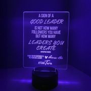 custom laser engraved sign with inspirational quote glowing in purple LEDs