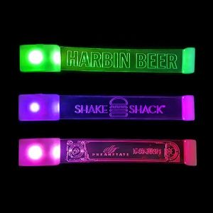 Three different laser engraved LED wristband designs for marketing each glowing a different color from top to bottom: green, purple and pink