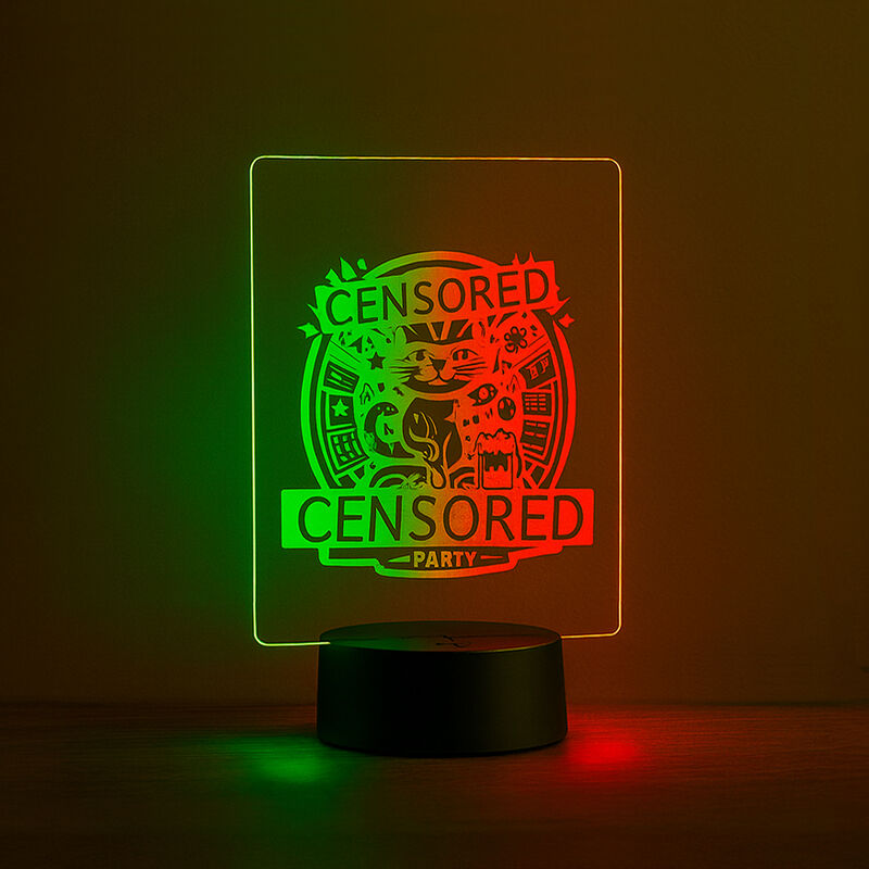 Dual-colored LED table sign with engraved ‘Censored Party’ design glowing in green and red on a table.