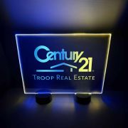 Bright LED acrylic sign for Century 21 real estate, showcasing blue and yellow lights designed for table display